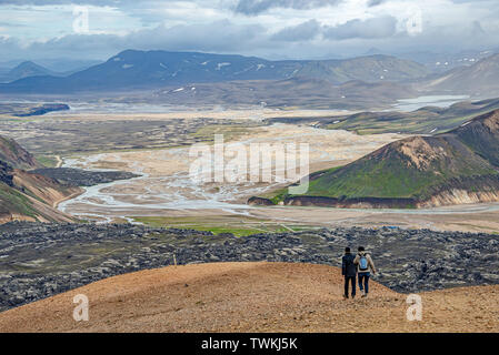 Panoramic view of colorful volcanic Landmannalaugar region and lava field called Laugahraun with hikers in Iceland, summer time, dramatic scene Stock Photo