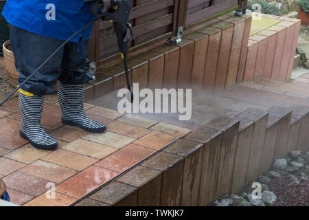 Close-up, cleaning the ceramic tiles of the floor with high pressure water scrubber Stock Photo