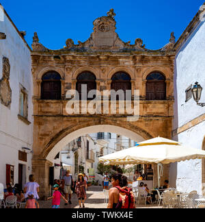 Ostuni, Italy - 24 June 2018: tourists observe the pleasant charm of the cathedral square in Ostuni, Puglia. Italy Stock Photo