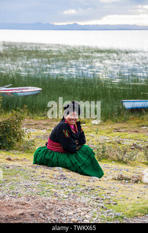 Local people in traditional dress on Luquina Chico, Lake Titicaca, Peru, South America Stock Photo