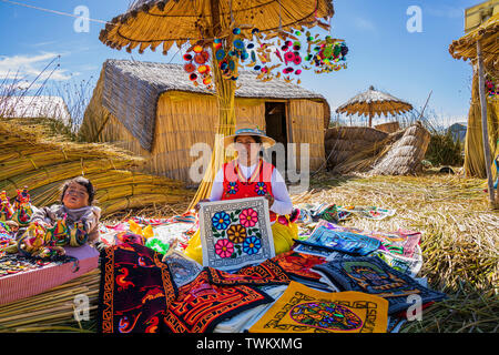 Handmade artisan goods and stitched textiles for sale on the Uros islands, reed floating islands on Lake Titicaca, Peru, South America Stock Photo