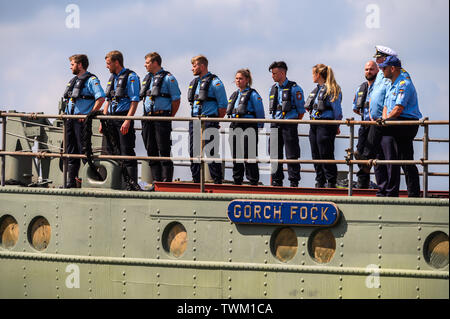 Bremerhaven, Germany. 21st June, 2019. Crew members stand at the dock of the naval training sailboat 'Gorch Fock'. The naval training ship 'Gorch Fock' is being launched in Bremerhaven today after more than three years in the dock. Credit: Mohssen Assanimoghaddam/dpa/Alamy Live News Stock Photo