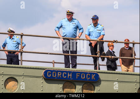 Bremerhaven, Germany. 21st June, 2019. Crew members stand at the dock of the naval training sailboat 'Gorch Fock'. The naval training ship 'Gorch Fock' is being launched in Bremerhaven today after more than three years in the dock. Credit: Mohssen Assanimoghaddam/dpa/Alamy Live News Stock Photo