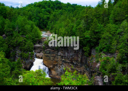 Blue Ridge Parkway, North Carolina - June 12, 2019:  Tourist and hikers can be seen at the overlook at the top of Linville Waterfall in the Blue Ridg Stock Photo