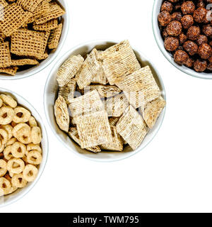 Selection of Bowls of Healthy Eating Breakfast Cereal Including Shredded Wheat Chocolate Nesquik Shreddies and Cheerios Stock Photo