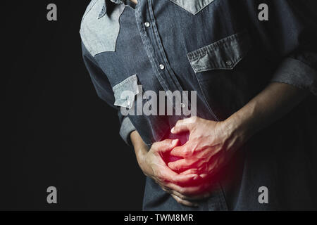Male suffering from stomachache pain. A man stomachache for healthy concept. Stock Photo