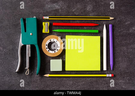 Assorted of school supplies on black slate. Back to school concept. Stock Photo