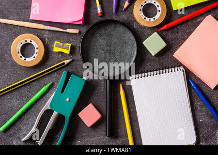 Assorted of school supplies on black slate. Back to school concept. Stock Photo
