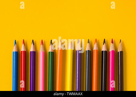 Color pencils on yellow background. Copyspace Stock Photo