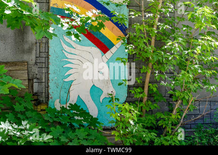 Wood board painted with a Unicorn and rainbow. Stock Photo