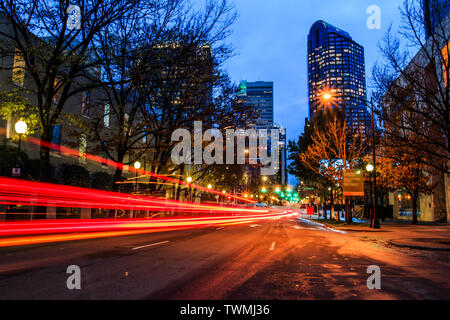 Vehicle moving in a fast speed in the downtown at dusk Stock Photo