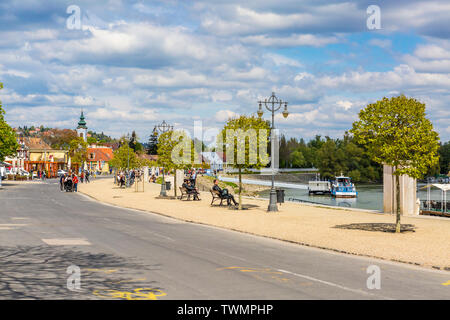 Tourists relaxing by the river Danube on a sunny spring morning at Szentendre, Hungary Stock Photo