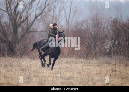 Pietrosani, Romania - January 6, 2019: Man is bareback riding an adorned horse before an Epiphany celebration horse race. Stock Photo