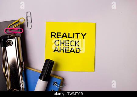 Reality Check Ahead on sticky notes isolated on white background. Stock Photo
