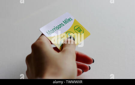 LONDON, UK, March 2019 Woman's holding Morrisons Miles Loyalty Card, Reward, Customer Point Card for fuel and food. Stock Photo