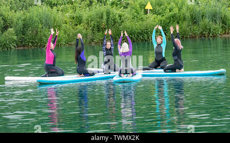 Upminster, Essex, UK. 21st June 2019. A new wellness initiative was launched today by Yogactive: Stand up Paddleboard Vinyasa yoga held at Stubbers Adventure Centre Upminster Essex Credit Ian Davidson/Alamy Live News Stock Photo