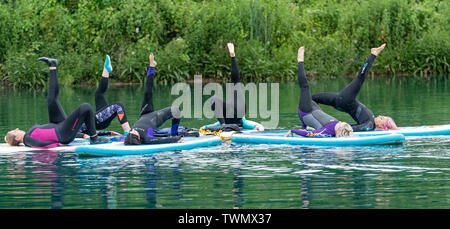 Upminster, Essex, UK. 21st June 2019. A new wellness initiative was launched today by Yogactive: Stand up Paddleboard Vinyasa yoga held at Stubbers Adventure Centre Upminster Essex Credit Ian Davidson/Alamy Live News Stock Photo