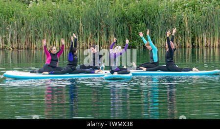 Upminster, Essex, UK. 21st June 2019. A new wellness initiative was launched today by Yogactive: Stand up Paddleboard Vinyasa yoga held at Stubbers Adventure Centre Upminster Essex Credit Ian Davidson/Alamy Live News Stock Photo