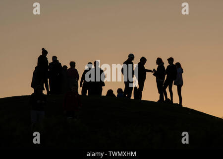 Pentyrch, Wales, UK, June 21st 2019. People gather on the top of Garth Hill as the sun sets on the summer solstice, the day of the year with the most sunlight. Credit: Mark Hawkins/Alamy Live News Stock Photo