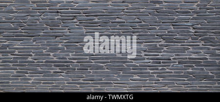 High resolution full frame background of an old wall made of gray stone slates. Copy space. Stock Photo