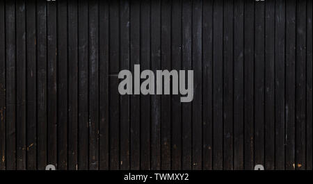High resolution full frame background of a weathered wood board wall or paneling painted in really dark gray. Copy space. Stock Photo