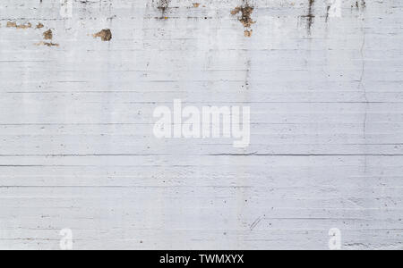 High resolution full frame texture background of a plastered, painted, uneven and a bit dirty white concrete wall. Paint is partly peeled off. Stock Photo