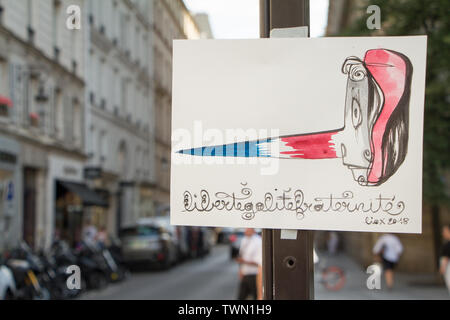 Paris, France - July 06, 2018: Figure on a pole with a Pinocchio mask and an inscription in French. Freedom Equality Brotherhood. Liberte, Egalite, Fr Stock Photo