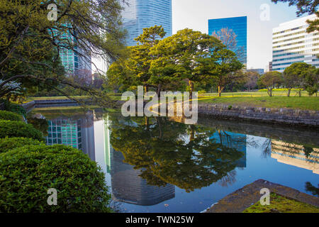 Hamarikyu Gardens  in Tokyo.  Contrast  of   urban   ( skyscrapers ) and nature - Hama-Rikyu  Garden. Stock Photo