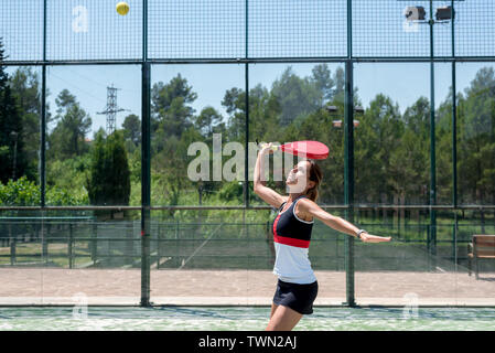 Woman playing padel outdoor Stock Photo