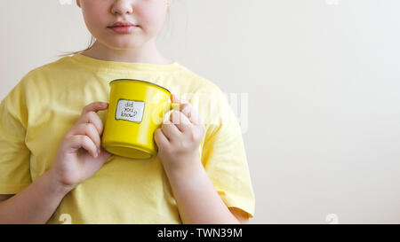 A girl with a yellow ring in her hand, on which was written Did you know Stock Photo