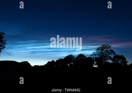 Teesdale, County Durham, UK.  22nd June 2019. UK Weather.  Beautiful noctilucent clouds light up the sky above Teesdale in North East England. These rare luminous clouds form due to ice crystals in the Earth's upper atmosphere and are only visible during astronomical twilight in the summer months. Credit: David Forster/Alamy Live News Stock Photo