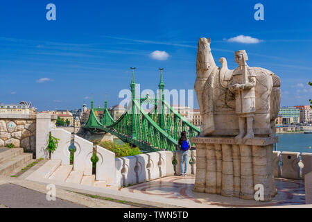 View of Liberty Bridge, River Danube and Budapest city center from Gellert Hill terrace with St Stephen King of Hungary monument Stock Photo