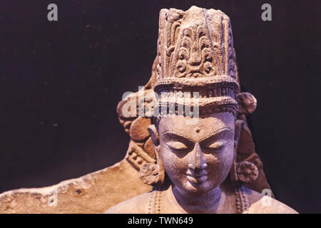 Ancient Indian sculpture of Crowned Buddha made of sandstone from fifth century common era Stock Photo