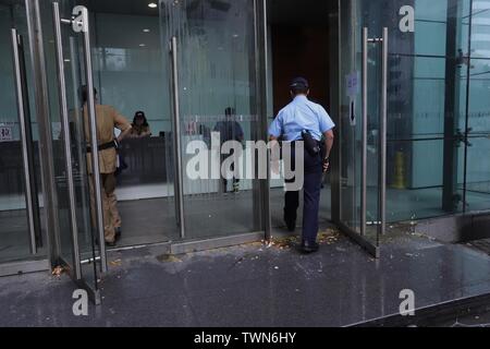 Hong Kong. 22nd June, 2019. Policeman walk over broken egg shells and slime as he enter Hong Kong Police Headquarters in the early morning after thousand of demonstrators surrounded Police Headquater last night condemning police brutality, demanding Police Chief Lo Wai-chung to offer formal apologies to the public. So far Lo have not responded to public outcry.June-22, 2019 Hong Kong.ZUMA/Liau Chung-ren Credit: Liau Chung-ren/ZUMA Wire/Alamy Live News Stock Photo