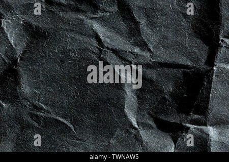 Macro image of the fibres on a crumpled black piece of newsprint Stock Photo