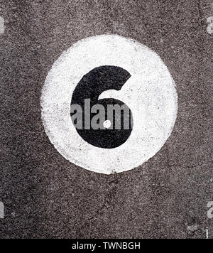Painted number six on a rendered wall Stock Photo