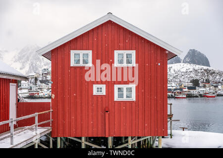 Red house of scandinavian style in snowfall on winter at lofoten islands Stock Photo