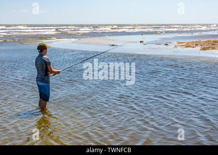 Sulina, Romania - A boy fishing in the Danube river near Sulina, Romania, on a sunny day Stock Photo