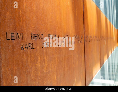 Bucharest, Romania - August 13th, 2018: Victims names written on rusty metal walls in the holocaust memorial in Bucharest, Romania Stock Photo