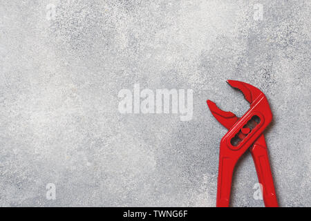 Red key for pipes and other metal products on a gray background. Copy space Stock Photo