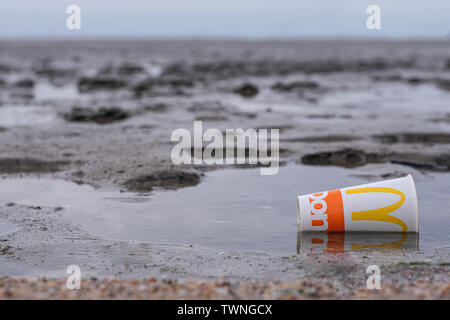 McDonalds cup littered on beach trash in cairns australia Stock Photo