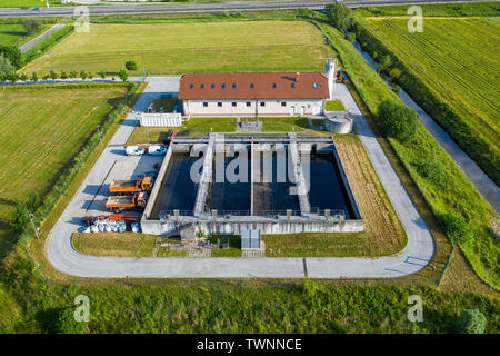 Aerial view of small sewage treatment plant with wastewater tanks and filters, fields with crops surrounding the plant, Slovenska Bistrica, Slovenia Stock Photo