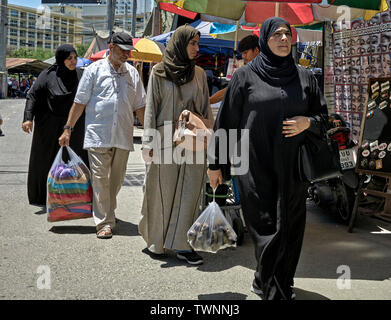 Arab family of three women in traditional dress and a man shopping. Thailand Southeast Asia Stock Photo