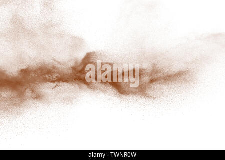 Explosion of deep brown powder on white background. Stock Photo