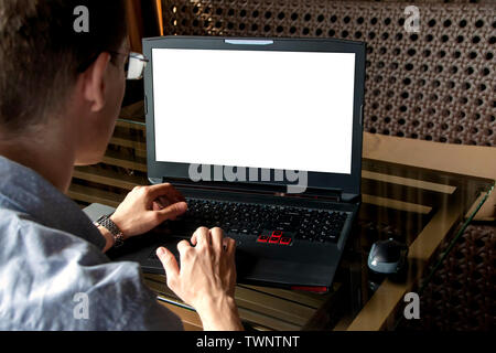 Man working on his laptop with mobile phone Stock Photo