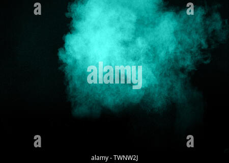 Abstract multicolored dust explosion on black background. Abstract color powder splash on dark background. Stock Photo