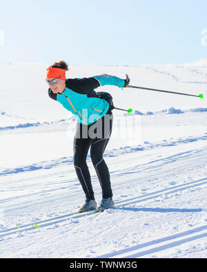 Cross-country skiing - young female athlete in perfect diagonal style Stock Photo