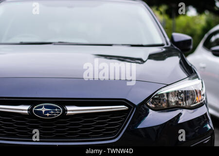 Subaru logo on black car in the city Stock Photo