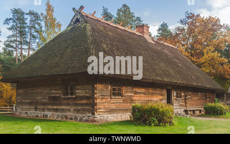 Autumn scene of Latvian traditional wooden dwelling house in the Ethnographic Open-Air Museum of Latvia. Stock Photo