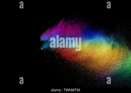 Abstract multicolored dust explosion on black background. Abstract color powder splash on dark background. Stock Photo